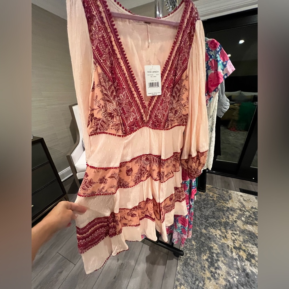 Free People mini dress. Low cut front and oversized sleeves.